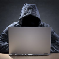 cyber liability insurance - hacker at computer